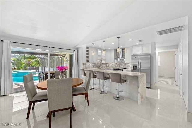 dining room with light tile patterned floors, lofted ceiling, recessed lighting, visible vents, and a sunroom