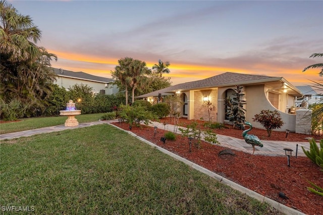 view of front of house with a front lawn and stucco siding