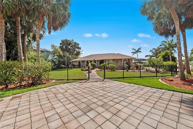 view of property's community featuring a gate, fence, and a yard