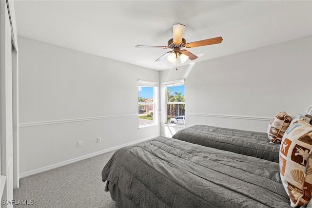 bedroom featuring ceiling fan, carpet, and baseboards