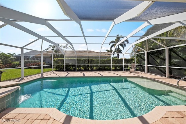 outdoor pool with a patio area and a lanai