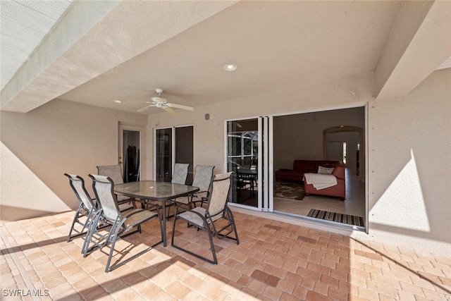 view of patio featuring outdoor dining space and ceiling fan