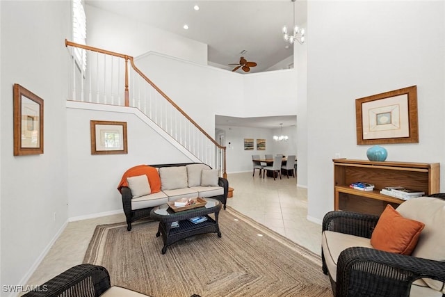 living area featuring tile patterned flooring, a towering ceiling, recessed lighting, and ceiling fan with notable chandelier