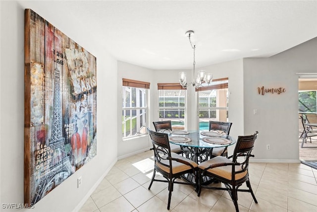 dining room with baseboards, a notable chandelier, and light tile patterned flooring