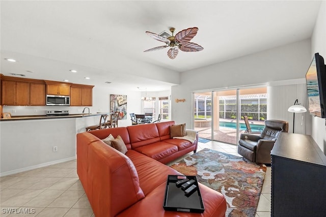 living area featuring ceiling fan, recessed lighting, plenty of natural light, and light tile patterned floors