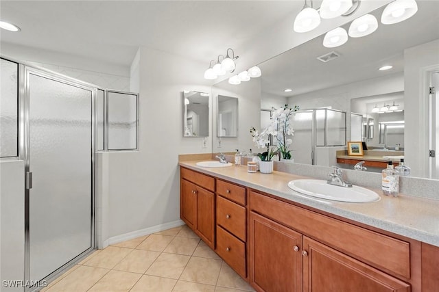 bathroom featuring tile patterned flooring, a sink, visible vents, and a shower stall