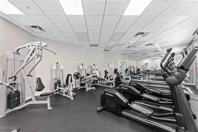 workout area with a drop ceiling and visible vents