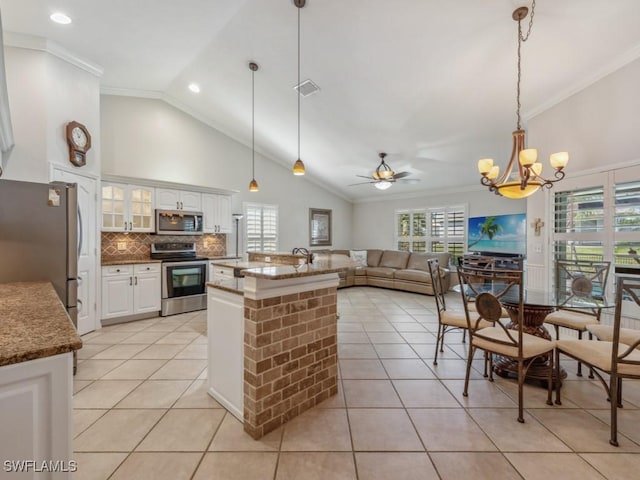 kitchen with white cabinetry, appliances with stainless steel finishes, light tile patterned floors, and pendant lighting