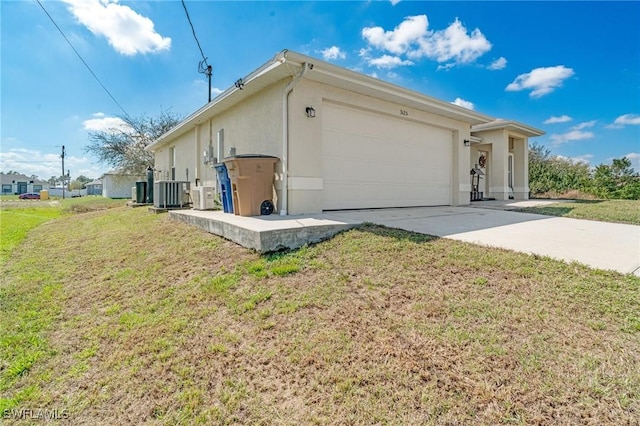 exterior space with concrete driveway, an attached garage, a yard, central air condition unit, and stucco siding