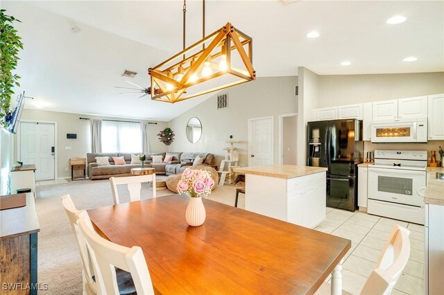 dining area featuring light tile patterned floors, visible vents, light colored carpet, vaulted ceiling, and recessed lighting