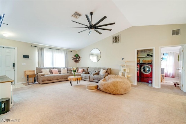 living room with light carpet, visible vents, and washer and dryer