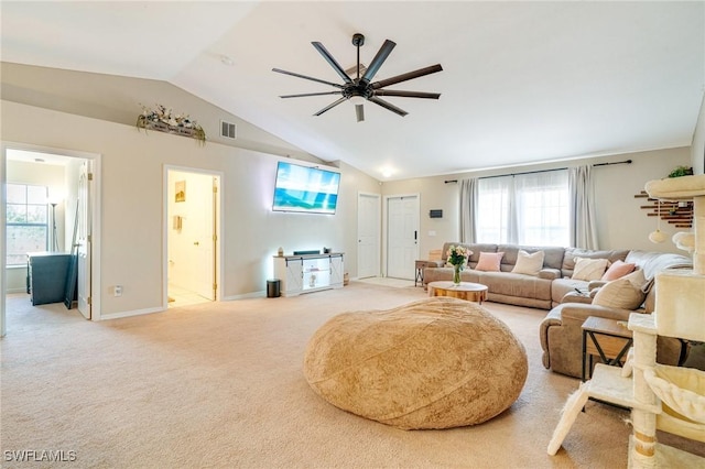 living room featuring ceiling fan, light carpet, visible vents, baseboards, and vaulted ceiling