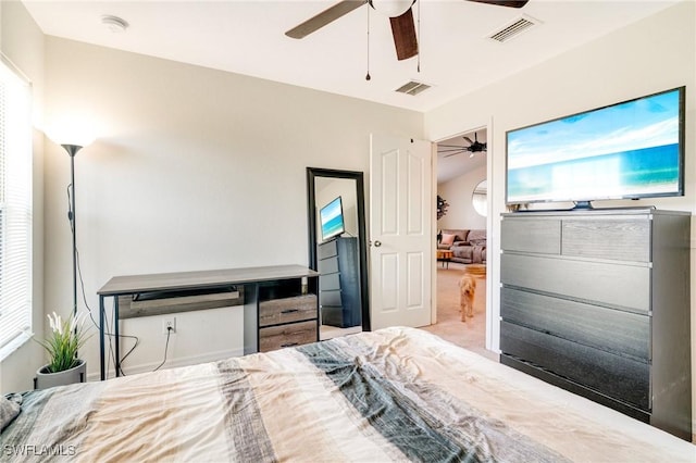 carpeted bedroom featuring visible vents and a ceiling fan