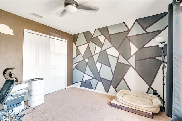 interior space featuring carpet, visible vents, and ceiling fan