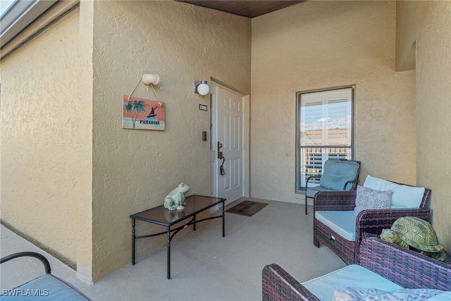 entrance to property featuring outdoor lounge area and a patio area