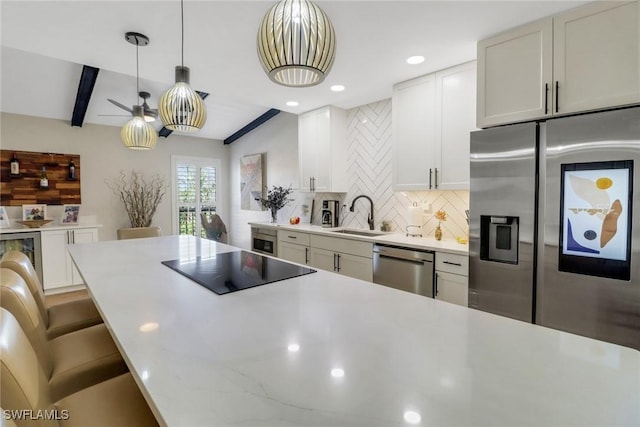 kitchen featuring sink, appliances with stainless steel finishes, backsplash, white cabinets, and beamed ceiling