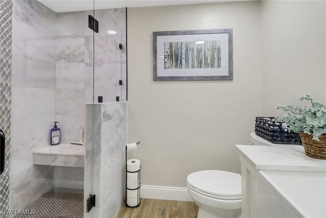 bathroom with an enclosed shower, wood-type flooring, and toilet