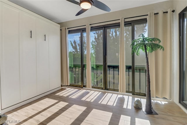 unfurnished sunroom featuring ceiling fan and a healthy amount of sunlight