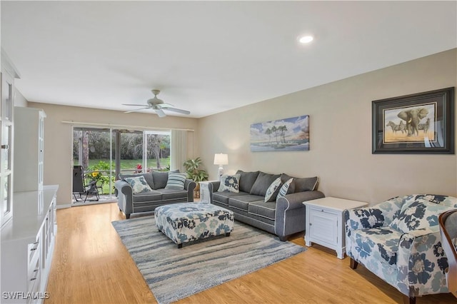 living area with light wood-style floors and ceiling fan