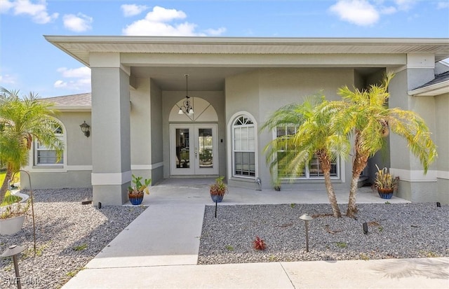 doorway to property with french doors and stucco siding