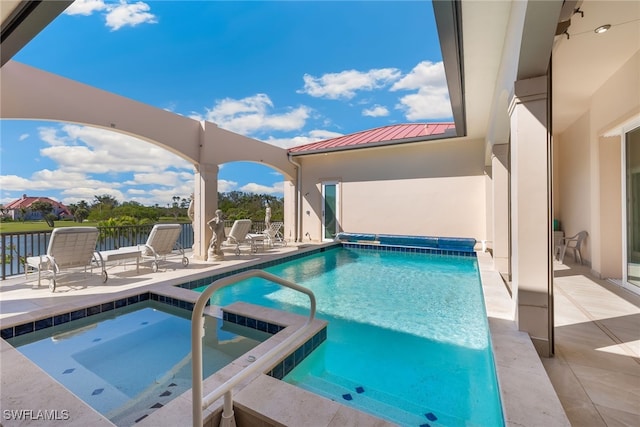 view of pool with a patio and a pool with connected hot tub