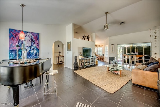 living room with dark tile patterned floors and lofted ceiling