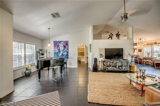 tiled living room featuring vaulted ceiling and ceiling fan