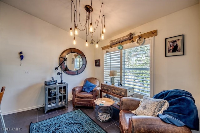 sitting room featuring a chandelier, dark tile patterned flooring, and vaulted ceiling