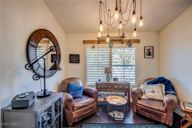 sitting room featuring an inviting chandelier and dark tile patterned flooring