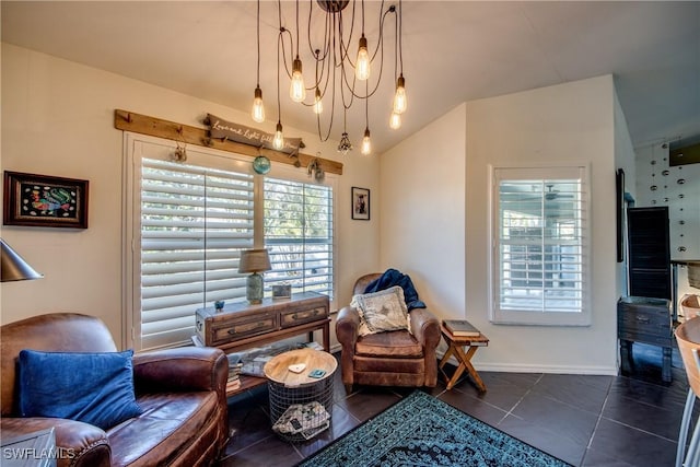 living area featuring a notable chandelier, vaulted ceiling, and a healthy amount of sunlight