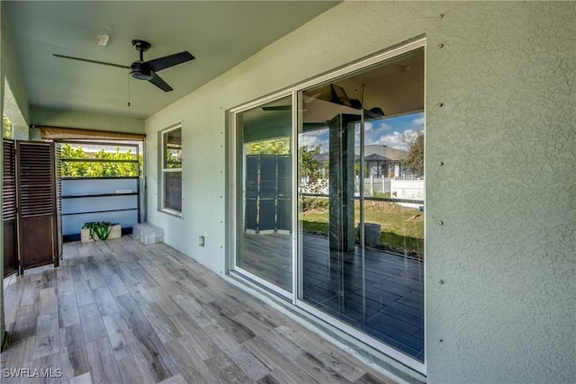 wooden terrace featuring ceiling fan