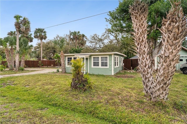 view of outbuilding featuring fence