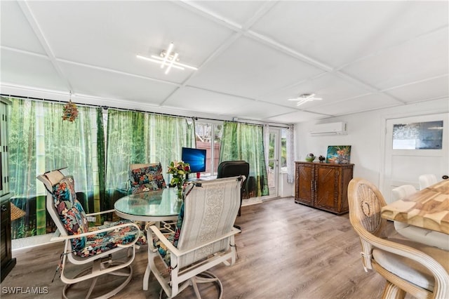 sunroom / solarium featuring a wall unit AC and a drop ceiling