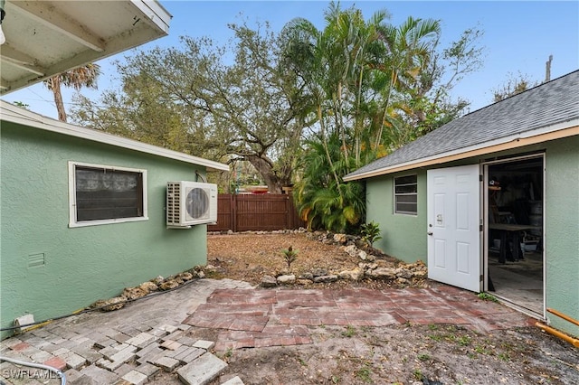 view of patio with ac unit and fence