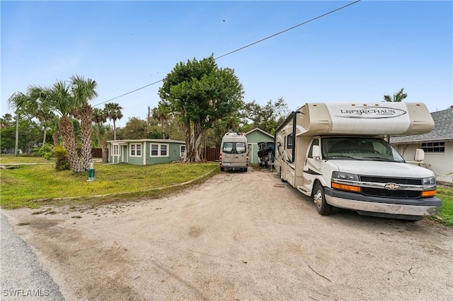 view of front of property with an outbuilding and a front yard