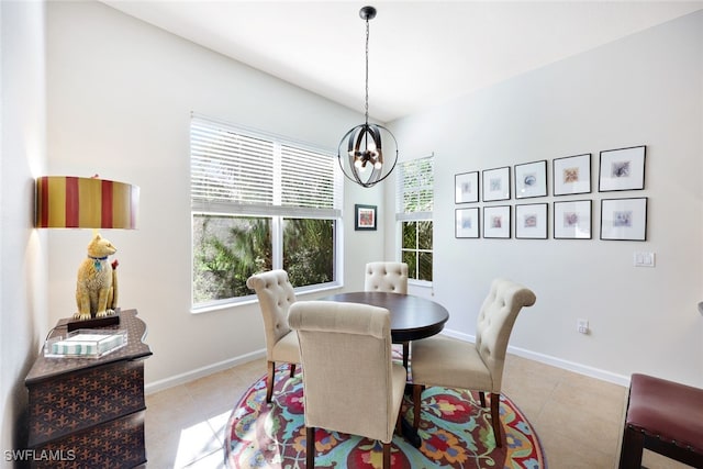 tiled dining space featuring an inviting chandelier