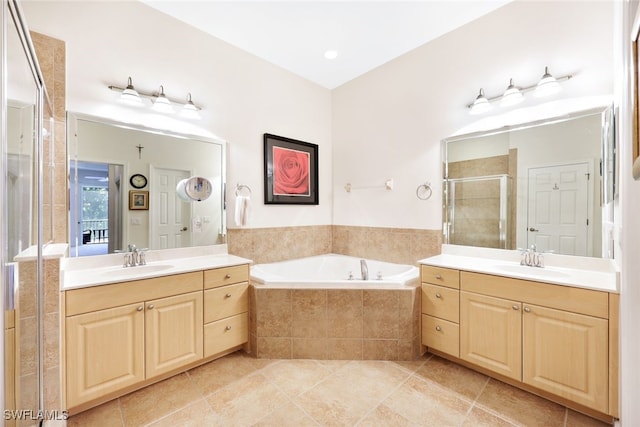 bathroom featuring vanity, independent shower and bath, and tile patterned flooring