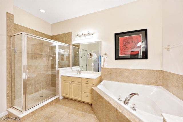 bathroom with vanity, shower with separate bathtub, and tile patterned flooring