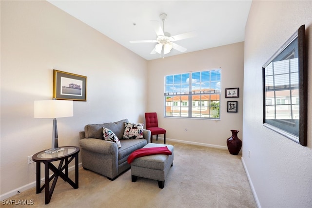 living area featuring ceiling fan, light colored carpet, and vaulted ceiling