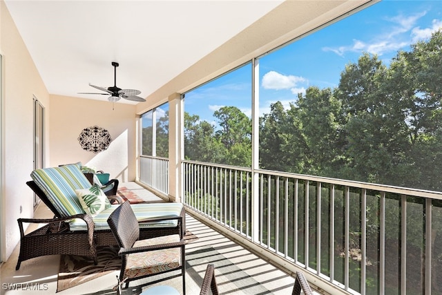 unfurnished sunroom featuring ceiling fan