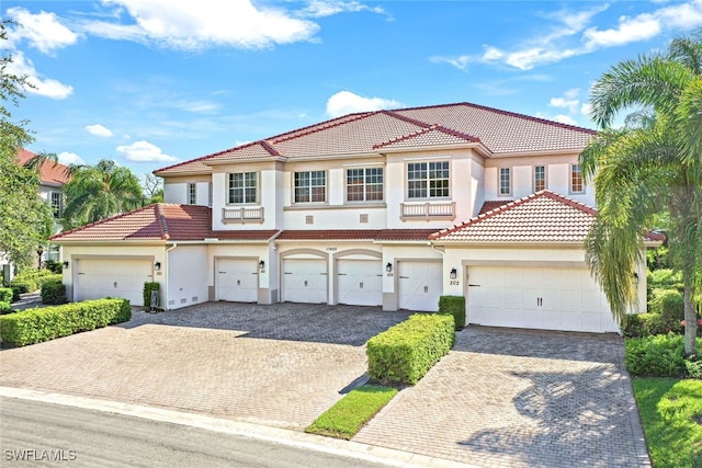 mediterranean / spanish home featuring a garage