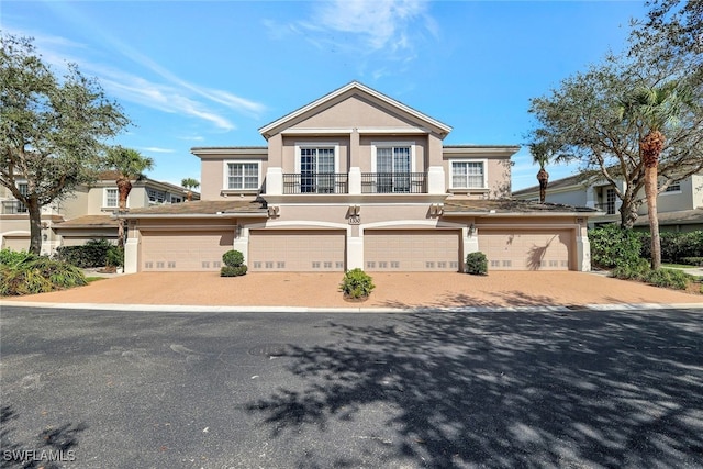 view of front of house featuring a balcony and a garage