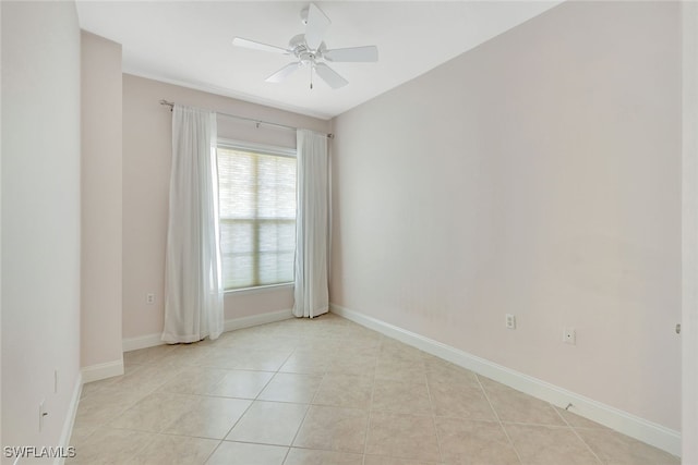 spare room with ceiling fan and light tile patterned floors