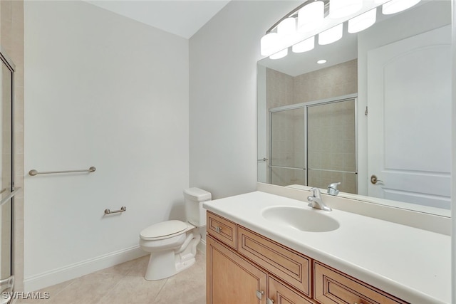 bathroom featuring tile patterned flooring, vanity, a shower with door, and toilet