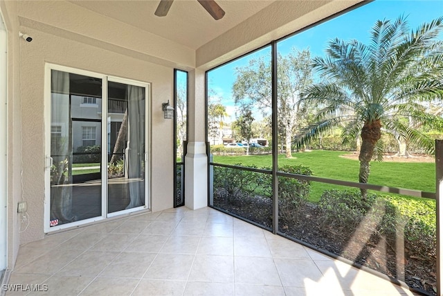 unfurnished sunroom with ceiling fan