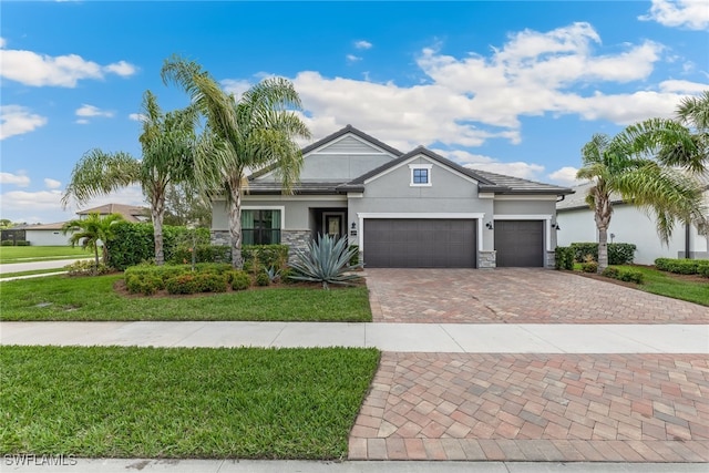 view of front of home with a garage and a front lawn