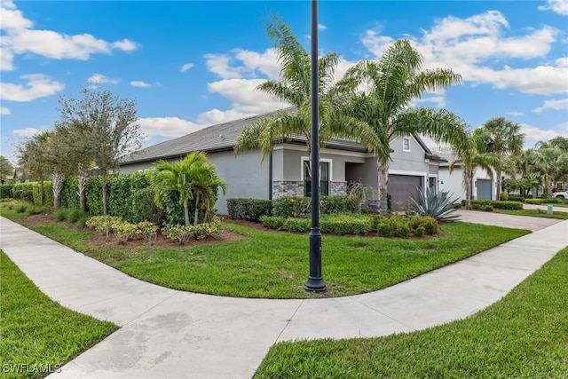 view of front of house with a garage and a front lawn