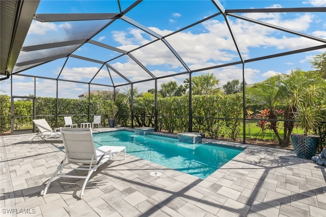 view of swimming pool featuring pool water feature, a lanai, and a patio area