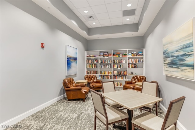 interior space featuring carpet and a paneled ceiling