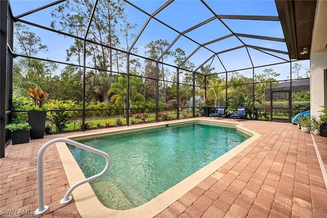 outdoor pool with a lanai and a patio area